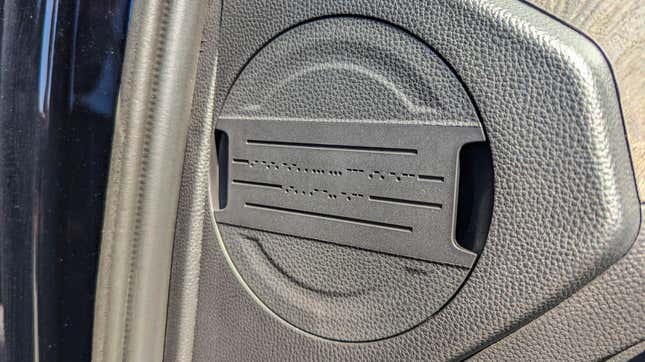 A removable cover on the side panel of the 2024 Toyota Tacoma's dashboard that reads "accessory ready" in Morse code